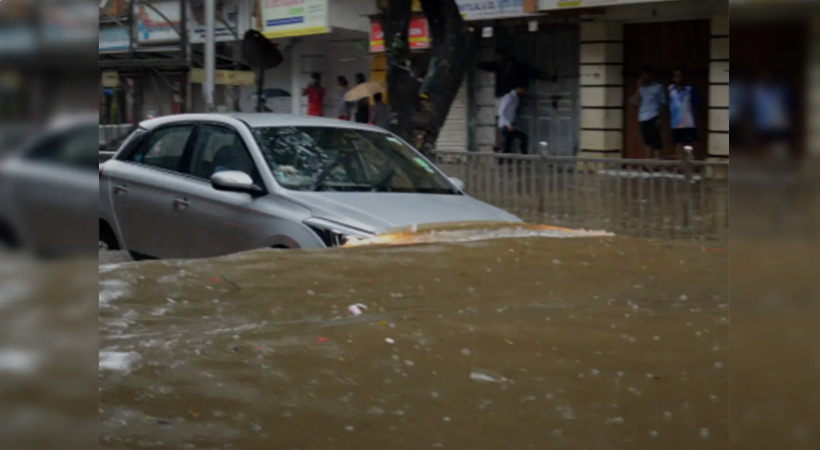 Flooded street in Nashik with submerged car highlighting severe potholes and drainage failure during monsoon.