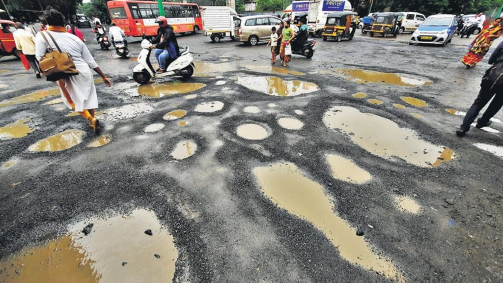 Nashik potholes causing traffic chaos and pedestrian difficulties during monsoon season.