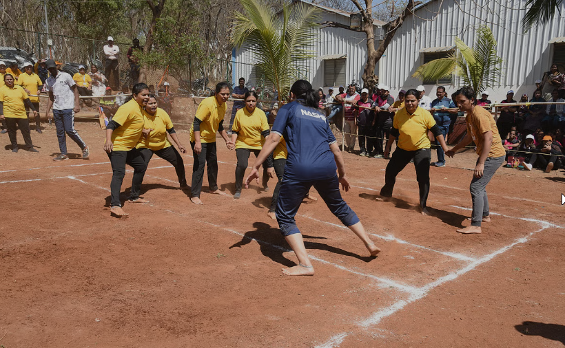 “Nashik Kabaddi match with women players showing teamwork, energy, and sports spirit on a clay ground during a local tournament
