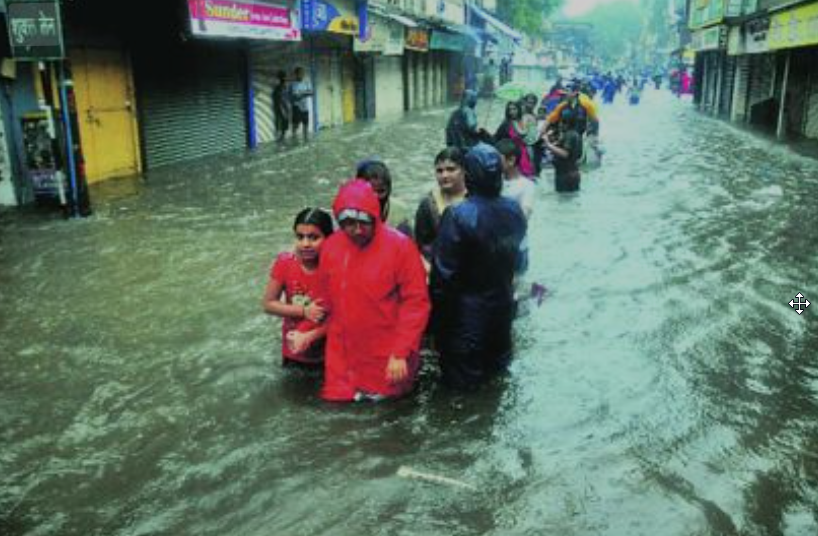 Nashik Flooding 2025 with residents wading through waist-deep water in Panchavati market after heavy rains submerged streets and shops
