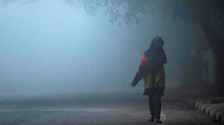 Nashik cold wave affecting daily life as a resident walks through dense winter fog during extreme cold conditions