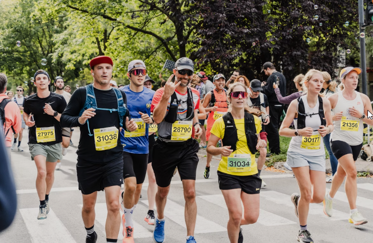 Runners participating in a vibrant outdoor race during Nashik Marathon 2025, showcasing athletes of all ages running through a green city route.